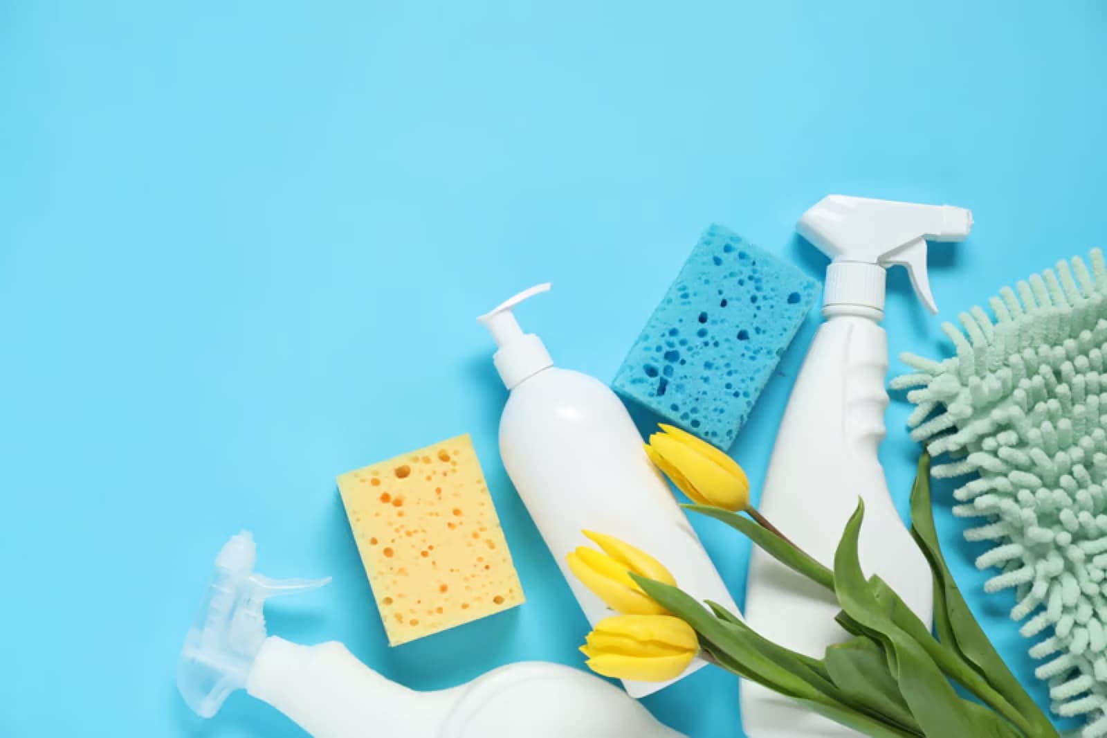 Cleaning supplies laid out on a blue background
